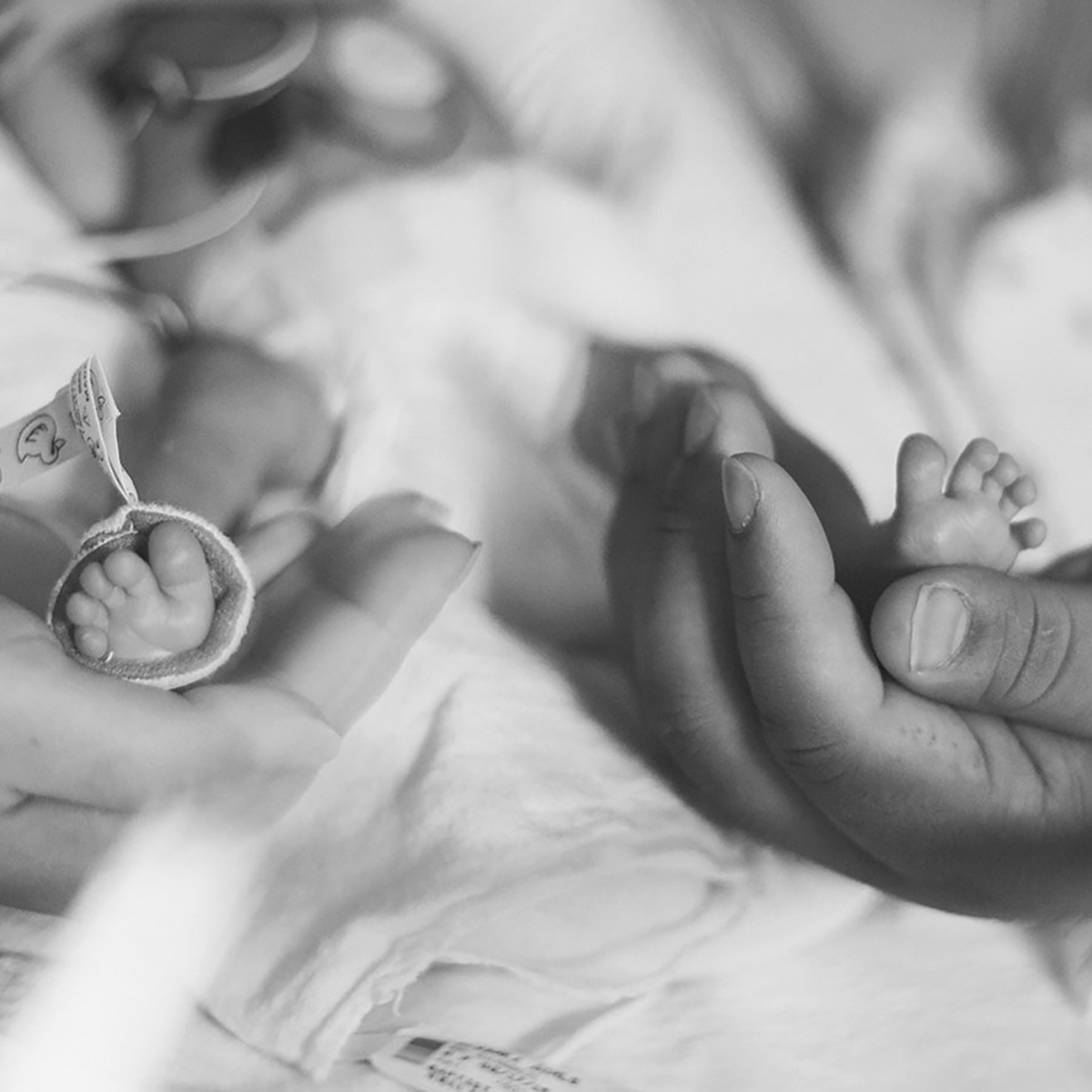 Parent holding a NICU baby's feet