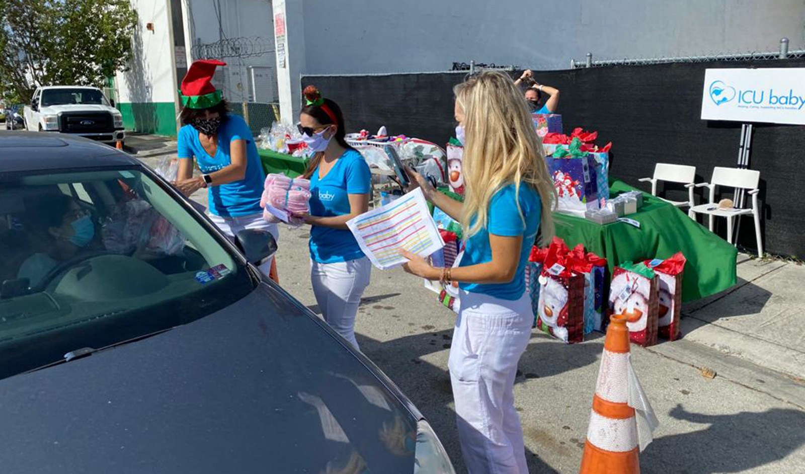 Giving out gifts at A “Drive-Thru” Christmas Celebration